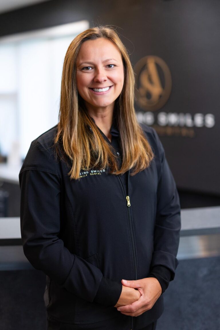 JJ Hygienist headshot at Amazing Smiles lobby. Smiling and wearing black scrub suitDr. Emily Hoang headshot at Amazing Smiles lobby. Smiling and wearing black scrub suit