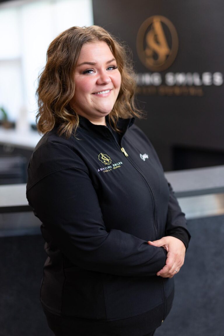 Jessy Hygienist headshot at Amazing Smiles lobby. Smiling and wearing black scrub suitDr. Emily Hoang headshot at Amazing Smiles lobby. Smiling and wearing black scrub suit