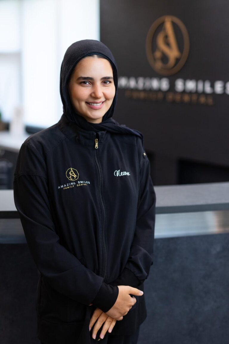 Newer Hygienist headshot at Amazing Smiles lobby. Smiling and wearing black scrub suitDr. Emily Hoang headshot at Amazing Smiles lobby. Smiling and wearing black scrub suit